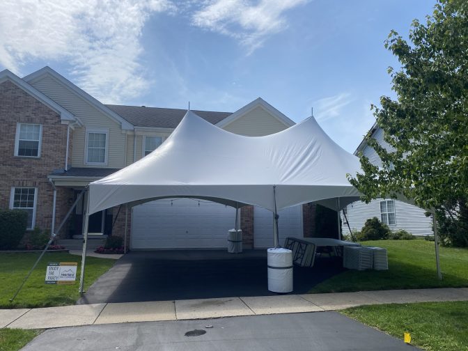 20×30 HP – West Dundee 20x30 high peak tent setup on a driveway