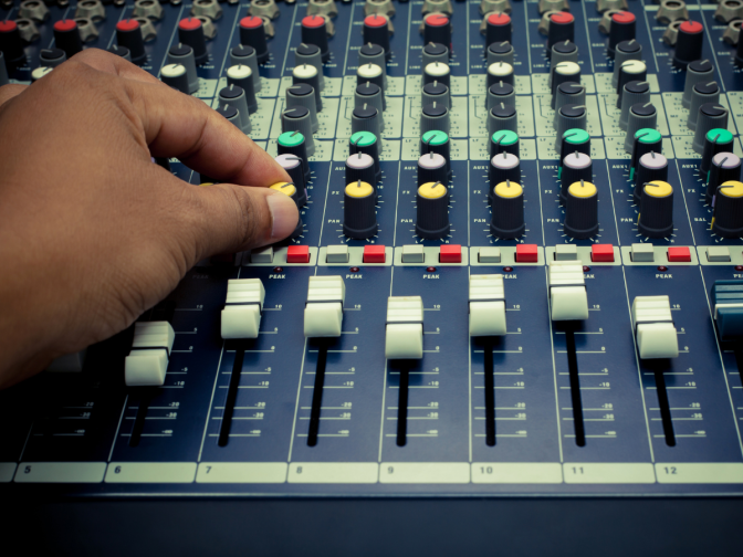 mixer Audio engineer adjusting a mixing board